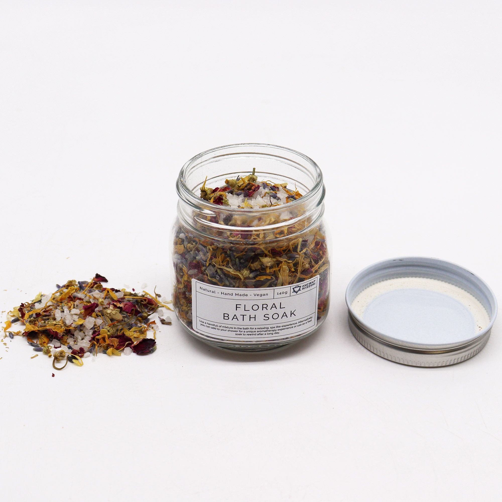 bain floral naturel aux plantes botaniques dans un pot en verre pour rituel de relaxation. Pot ouvert avec un couvercle à côté du pot et bain floral éparpillé de l'autre côté