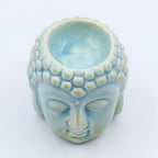 Vue du dessus du brûleur Bouddha bleu en céramique avec visage sculpté, décoration zen