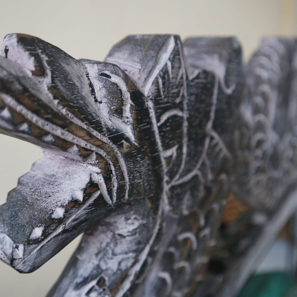 détail support en bois sculpté pour gong balinais artisanal, motif traditionnel et structure décorative