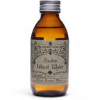 Flacon en verre ambré de l’eau rituelle île d'avalin avec étiquette vintage, inspirée des rituels de purification et de vitalité