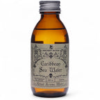 Flacon en verre ambré de l’eau rituelle mer des caraïbes avec étiquette vintage, inspirée des rituels de purification