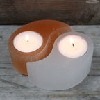 Photophores yin yang en selenite avec bougies allumees creant une ambiance zen et harmonieuse